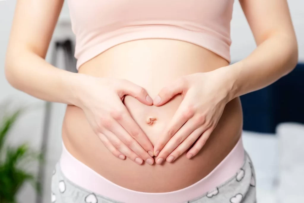 woman holding pregnant belly