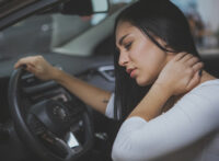 Woman with neck pain due to a auto accident
