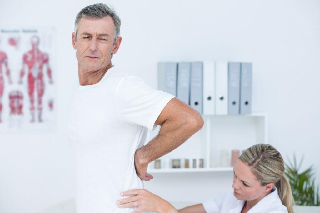 doctor examining patient's back