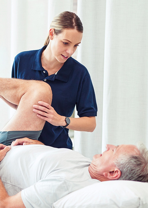 woman stretching mans leg