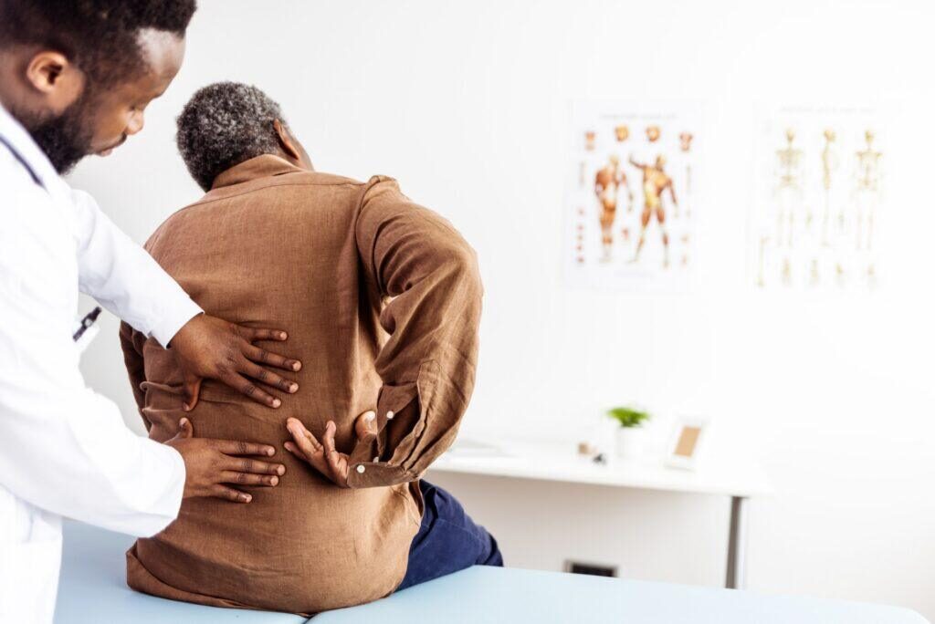 A chiropractor helping a patient