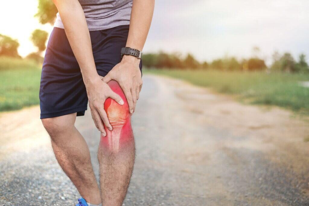 Man holding knee in pain