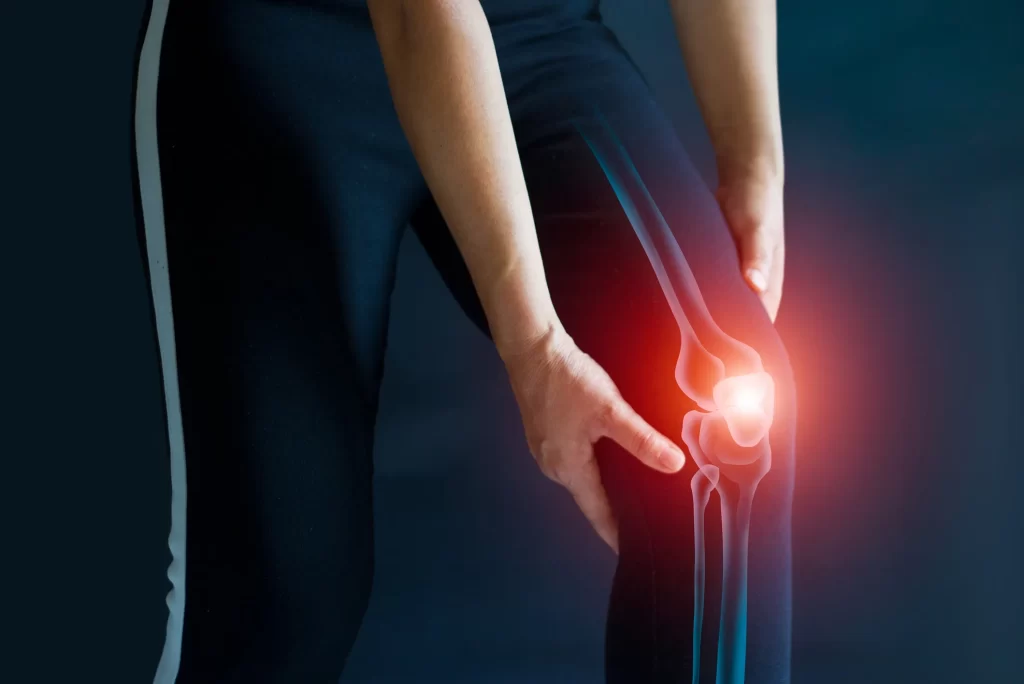Man holding knee in pain